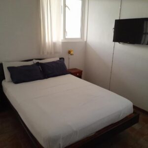 Double bedroom with white linen at Auberge Miko in Grand Baie