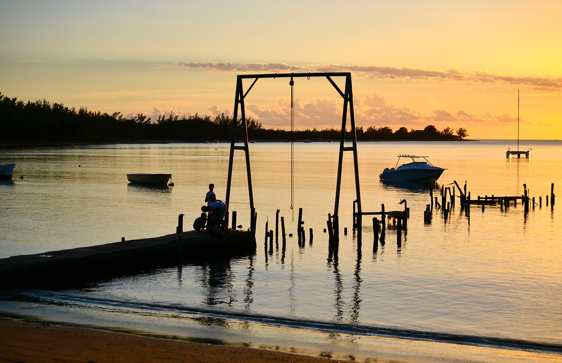 Sunset over a jetty in the lagoon at Belle Mare
