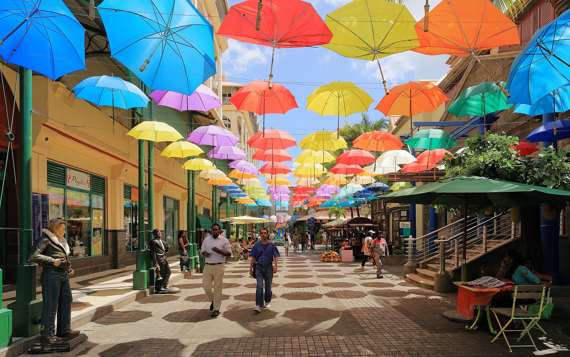 Coloured umbrellas suspended above a walkway at the Caudan Waterfront, Port Louis